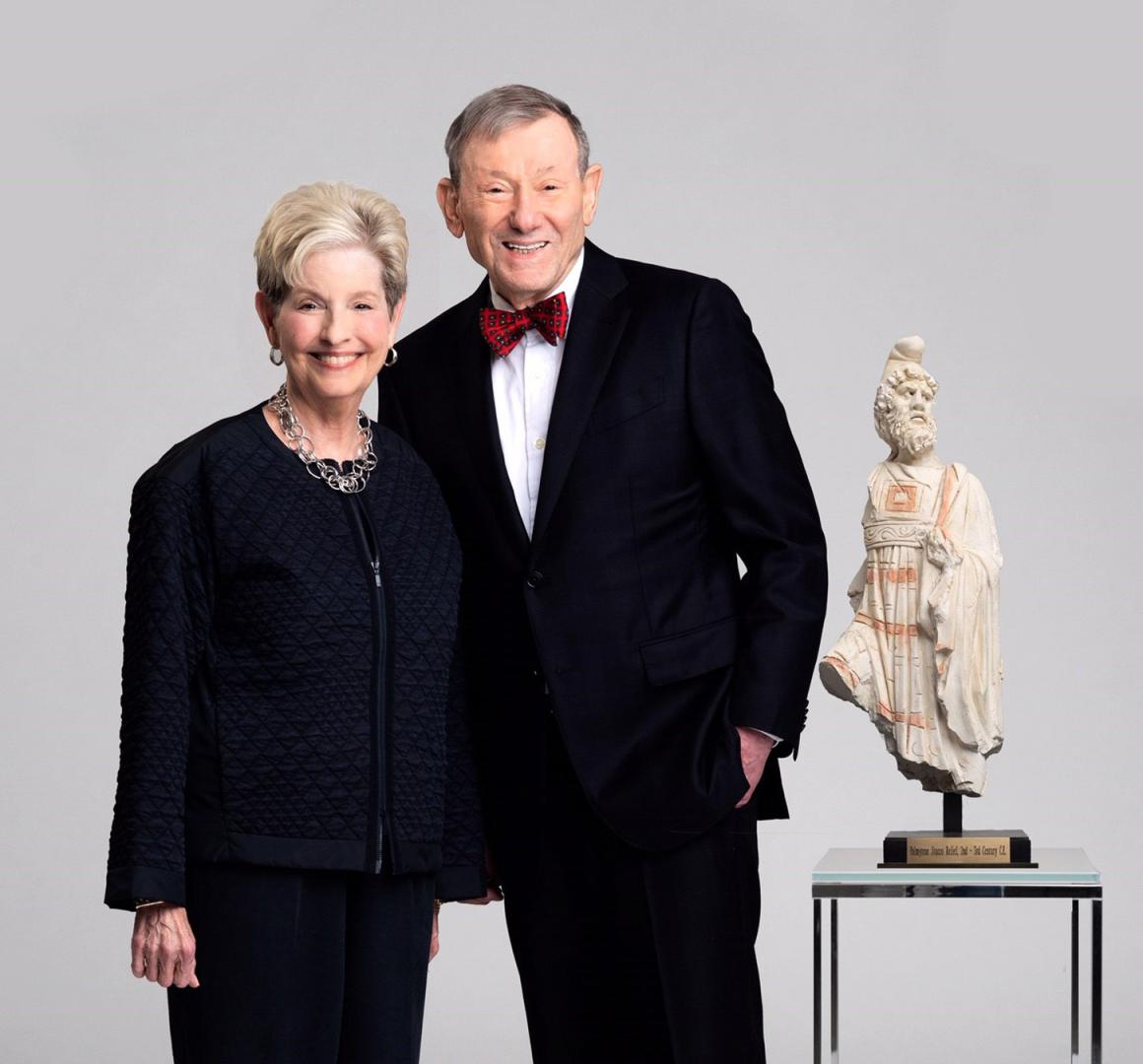 Donna and Hans Sternberg, standing alongside a work of art
