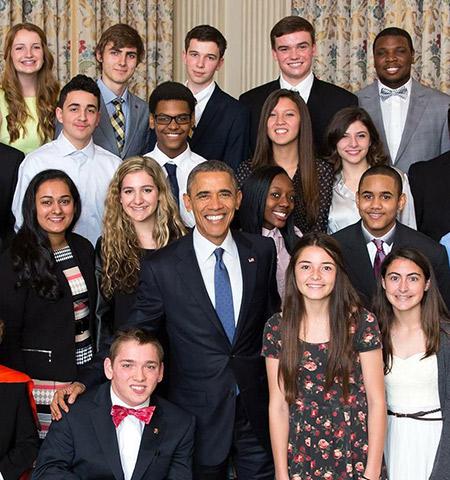 President Barack Obama, surrounded by student filmmakers at the White House