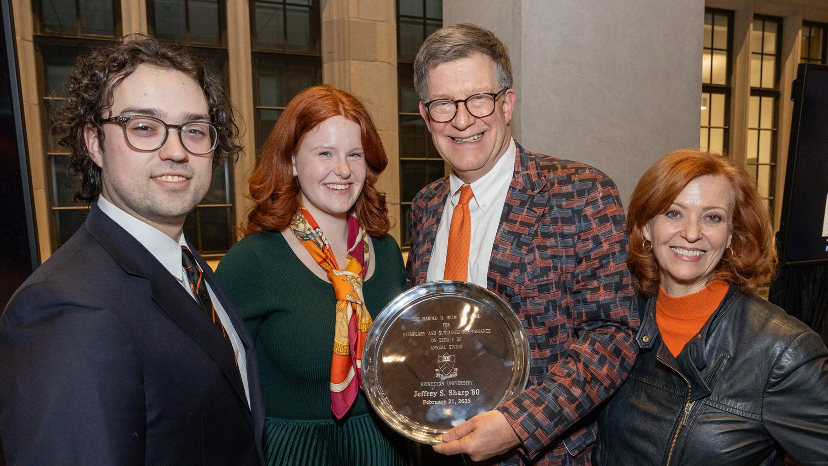 Jeff Sharp with his family as he holds the silver plated Helm Award
