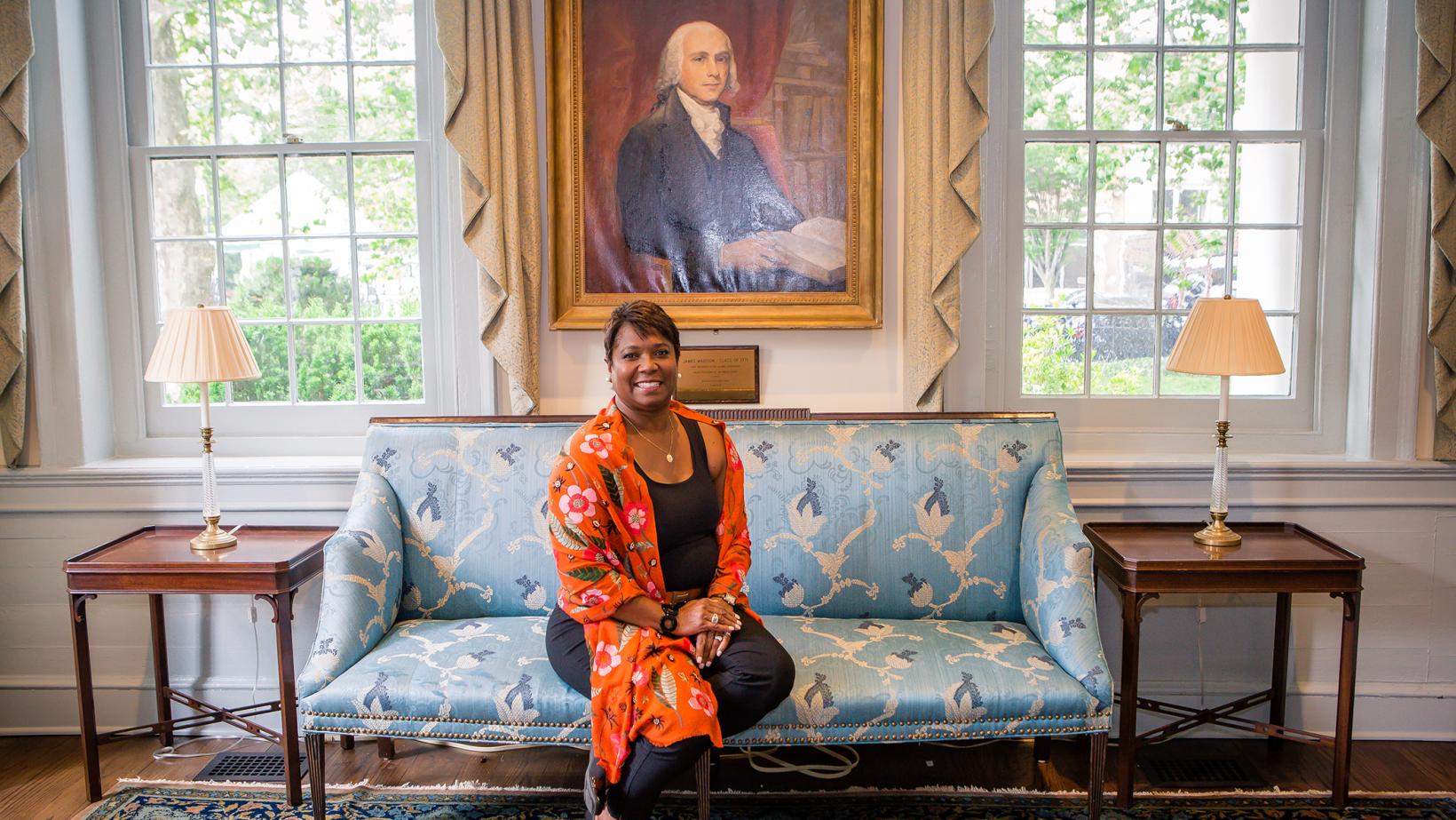Monica Moore Thompson seated in front of James Madison portrait