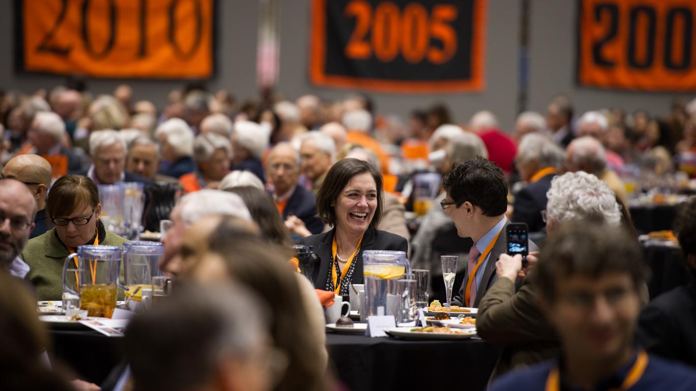 Alumni during Alumni Day in Jadwin Gym sitting at tables