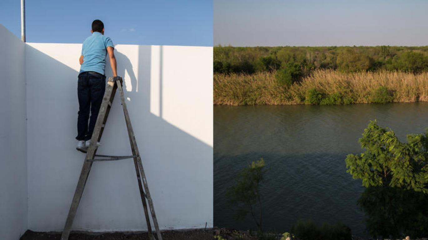 Man looking over a wall near water