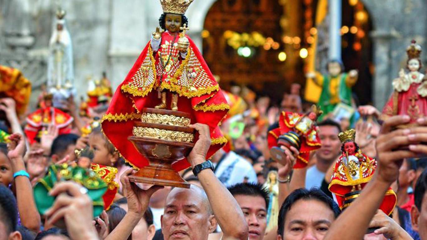 Philippine crowd holding religious figure