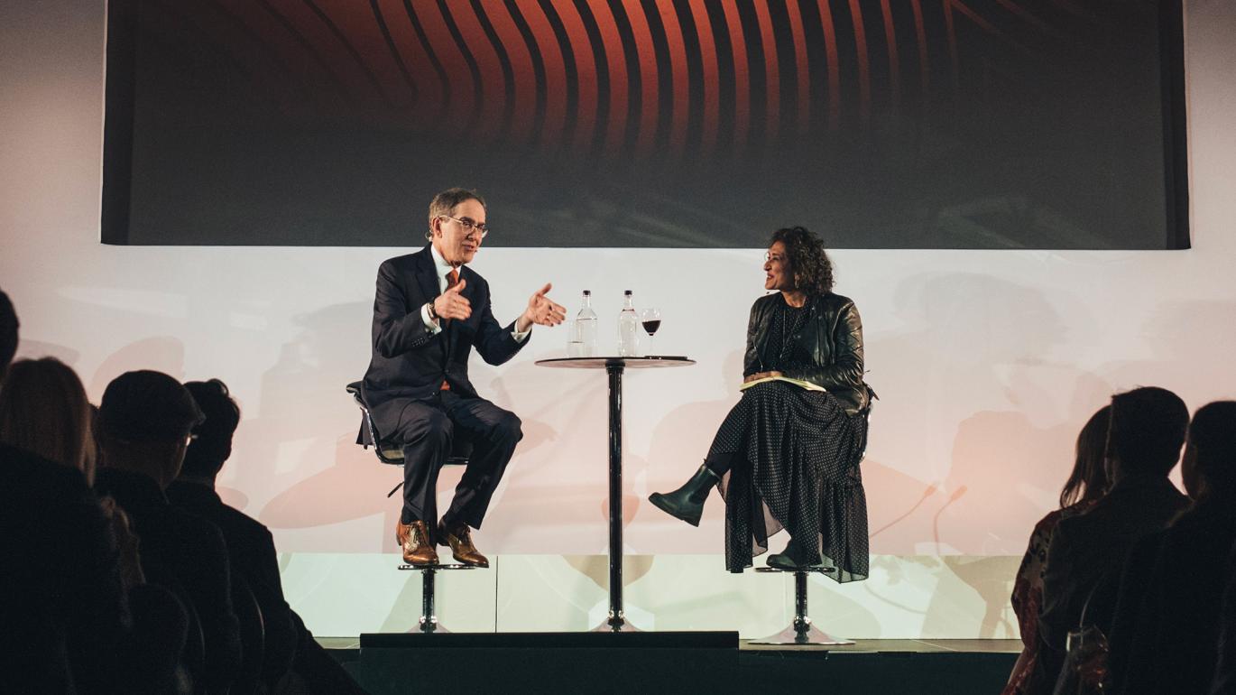 President Eisgruber '83, on stage in London, speaking with Razia Iqbal, BBC news anchor