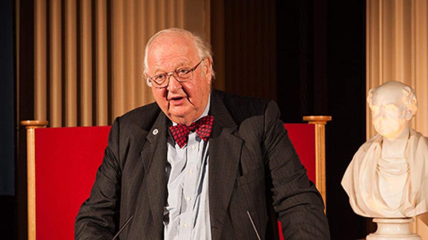 Sir Angus Deaton speaking from a podium