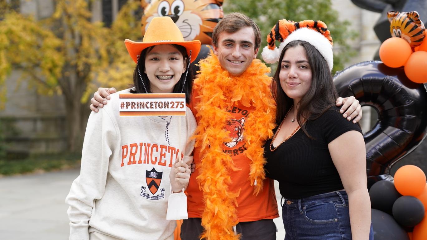 Alumni wearing orange and black with balloons