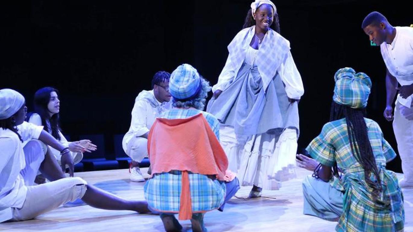 Students perform on stage with The Black Theater Initiative