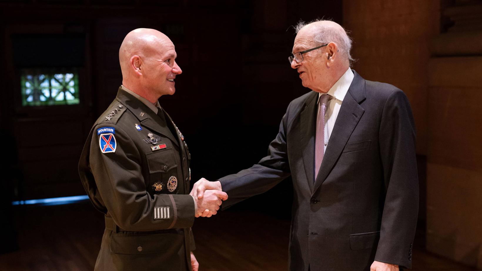 Gen. Christopher Cavoli and Robert Kahn shake hands during Alumni Day 2023