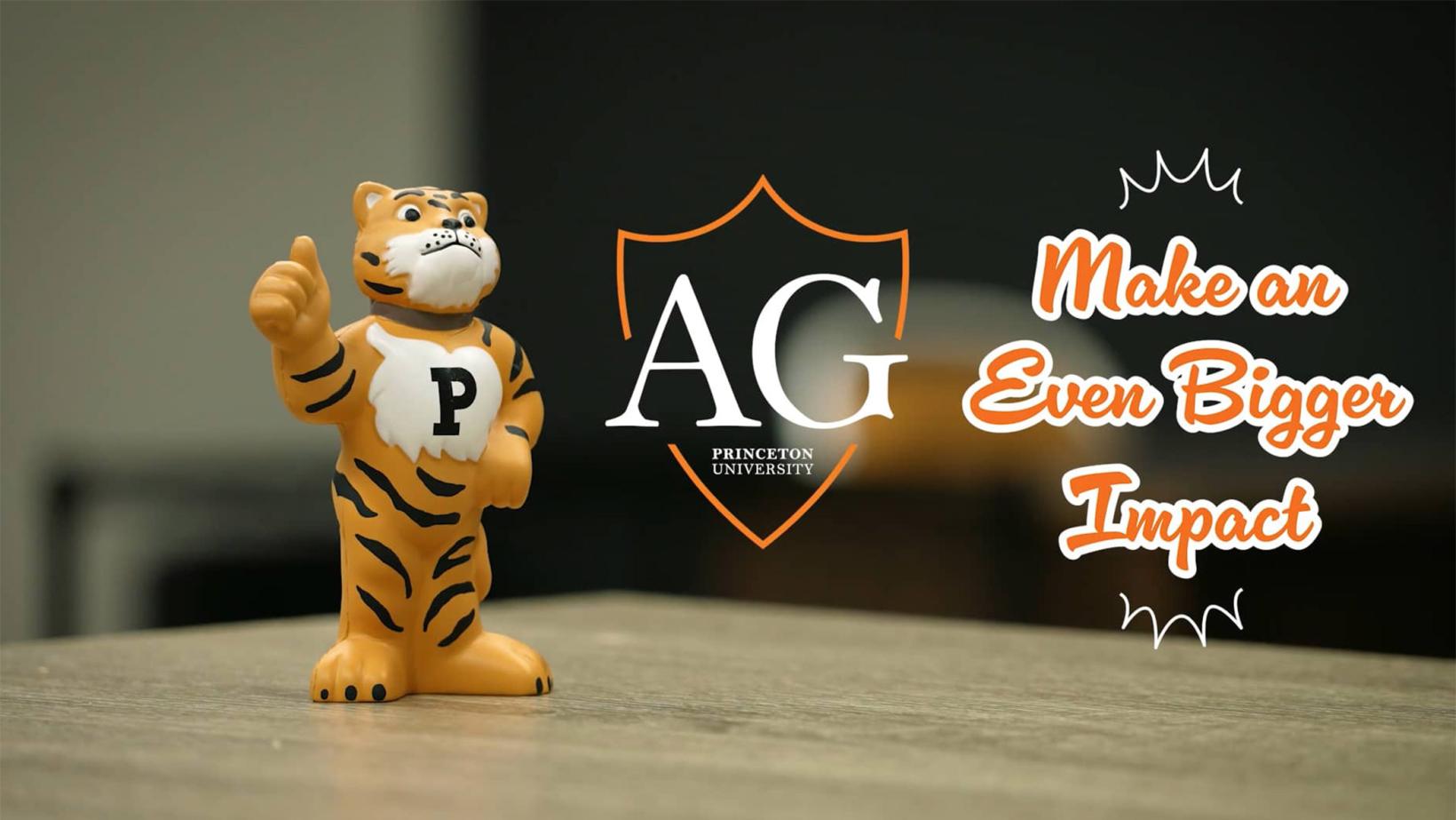 A toy Tiger stands on a desk, giving a thumbs-up gesture