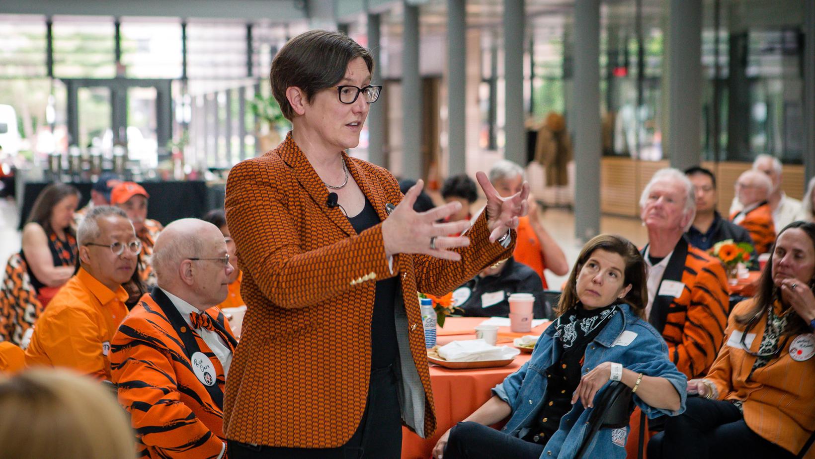 Provost Jennifer Rexford speaks to tables full of alumni