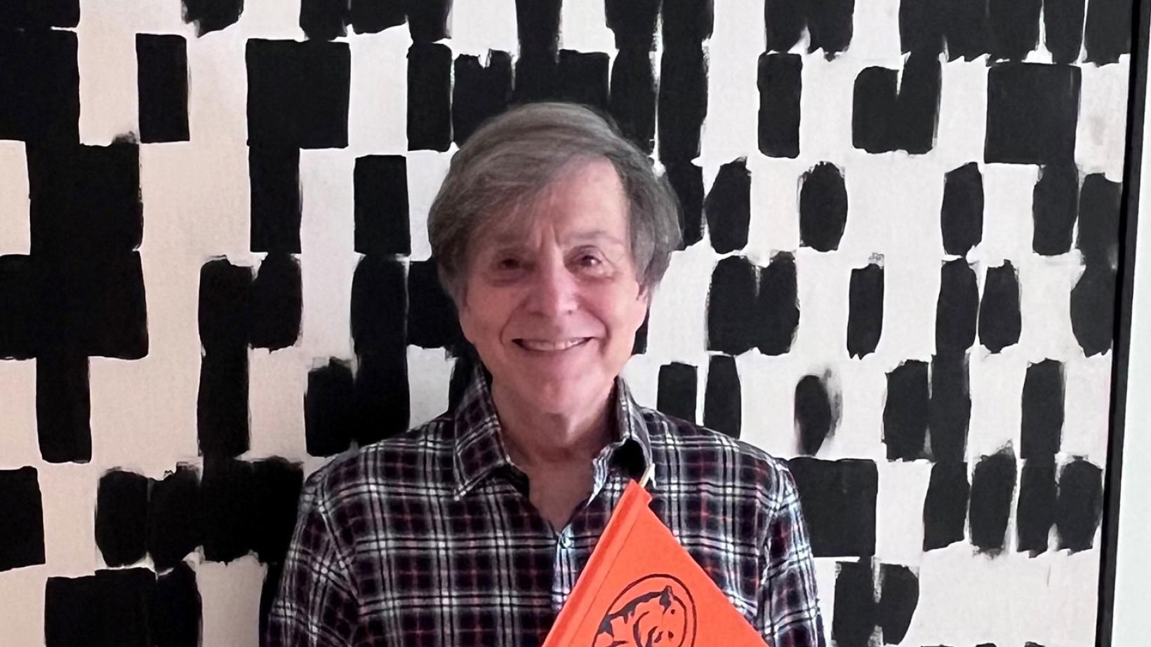 Headshot of Gary Forlini holding a 1746 Society pennant