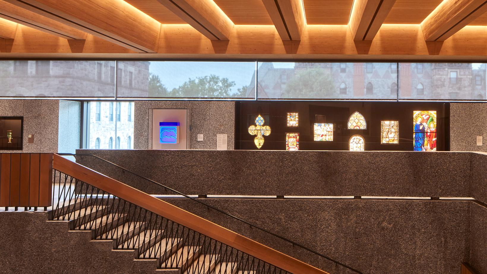 An interior of the Grand Stairs and oritnation gallery of the new Princeton University Art Museum, with campus showing through the glass