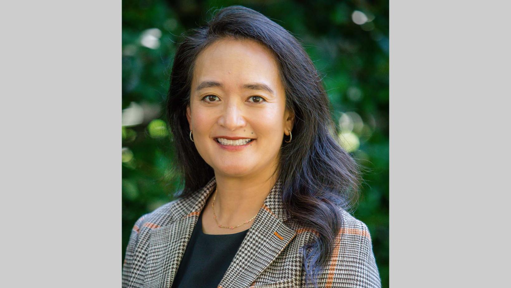 Portrait of April Chou with leafy green background