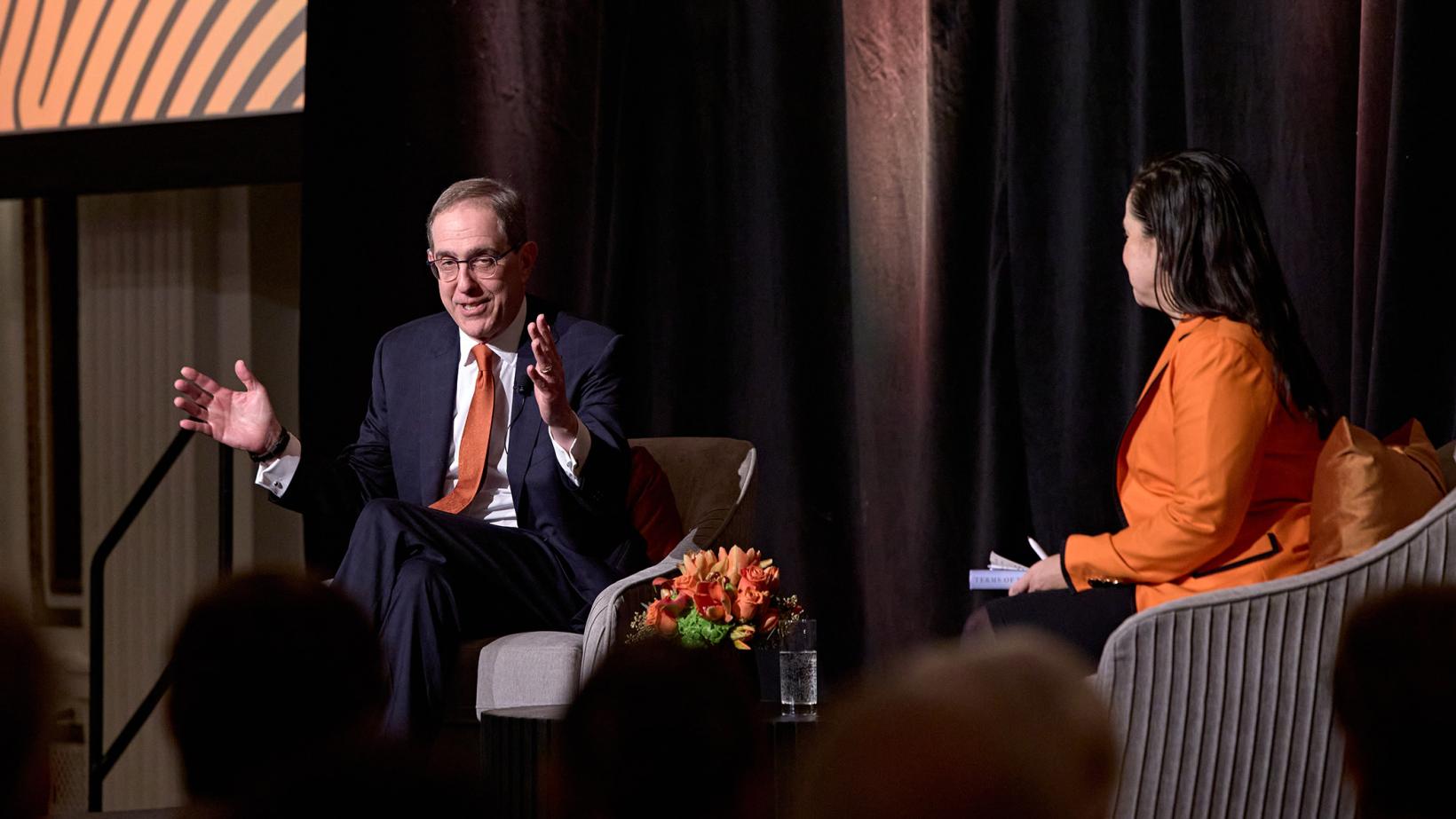 President Eisgruber gestures with his hands to make a point in his conversation on stage with Melissa Wu.