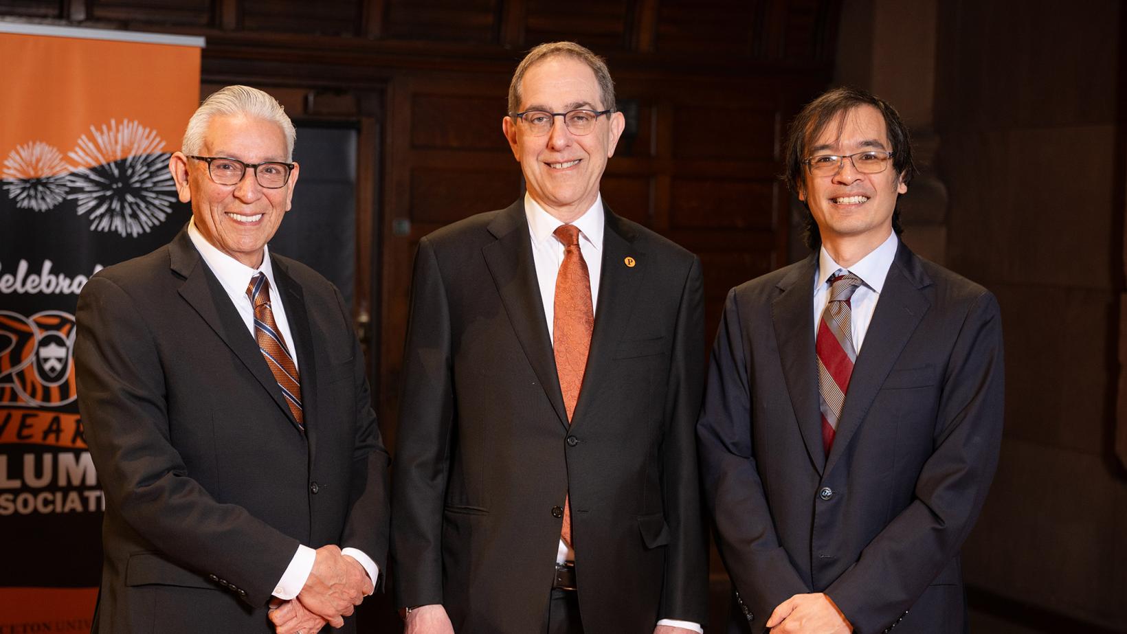 Kevin Gover, President Eisgruber and Terence Tao standing side by side on the stage of Richardson Auditorium.