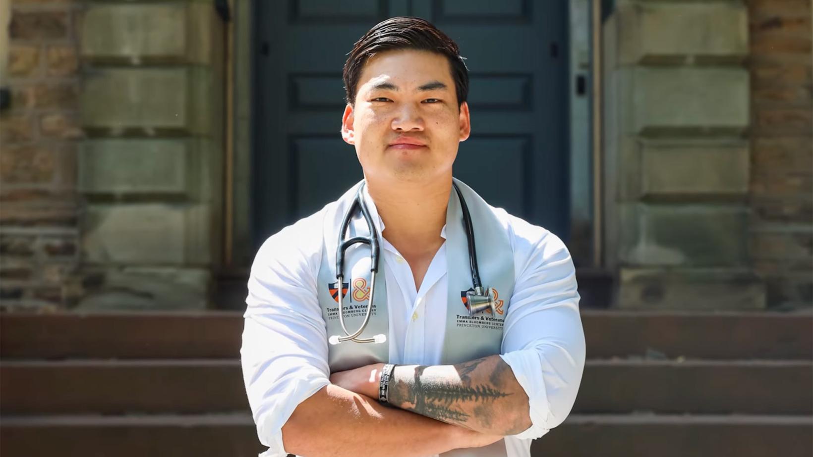Luke Hixon, standing in front of Nassau Hall with a stethoscope handing around his neck