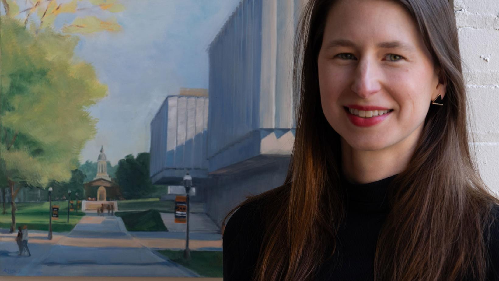 Headshot of Katherine Boyce with a painting behind her