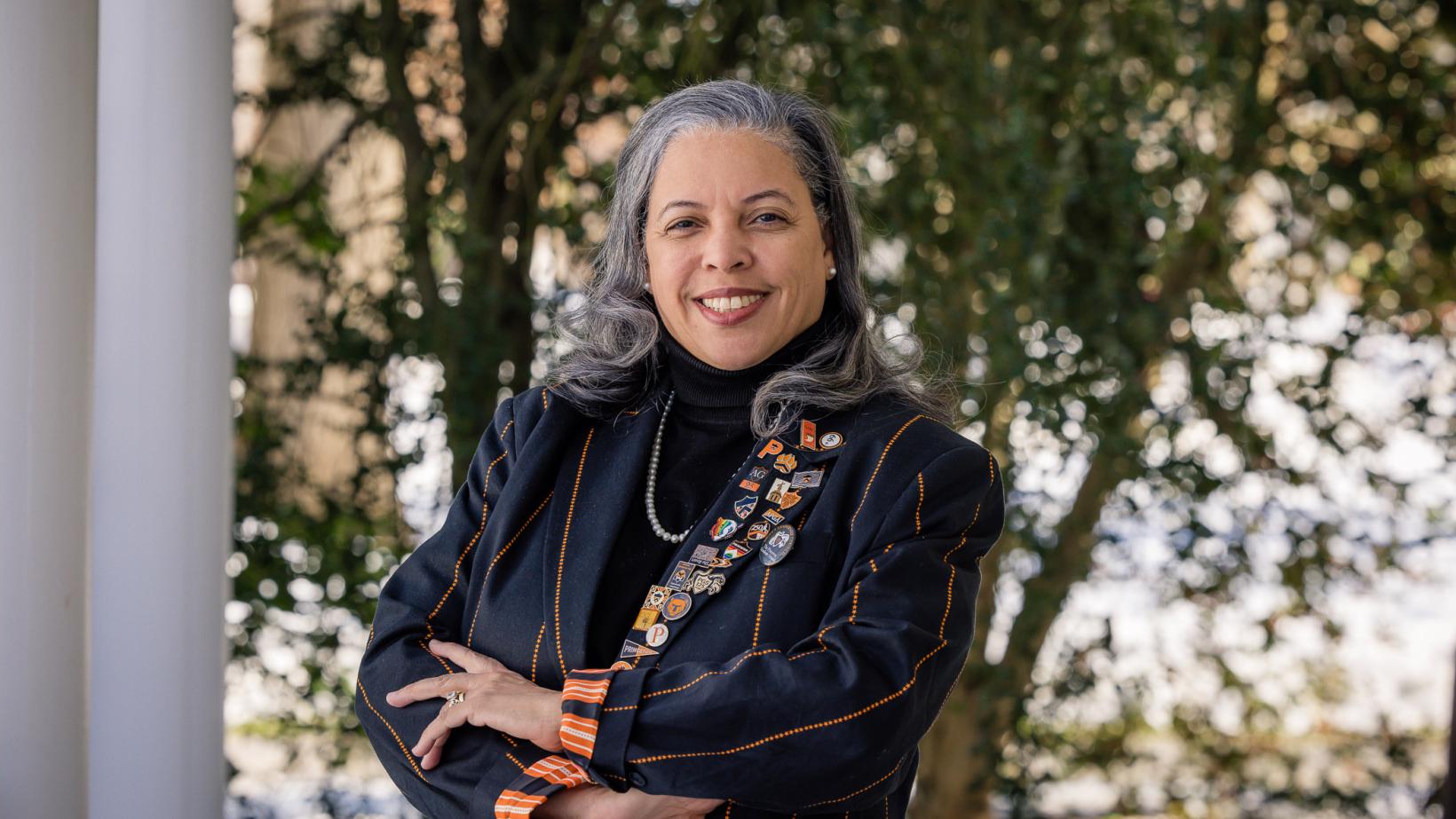 Patrice Jean, arms crossed, dressed in her orange-striped black Princeton blazer.