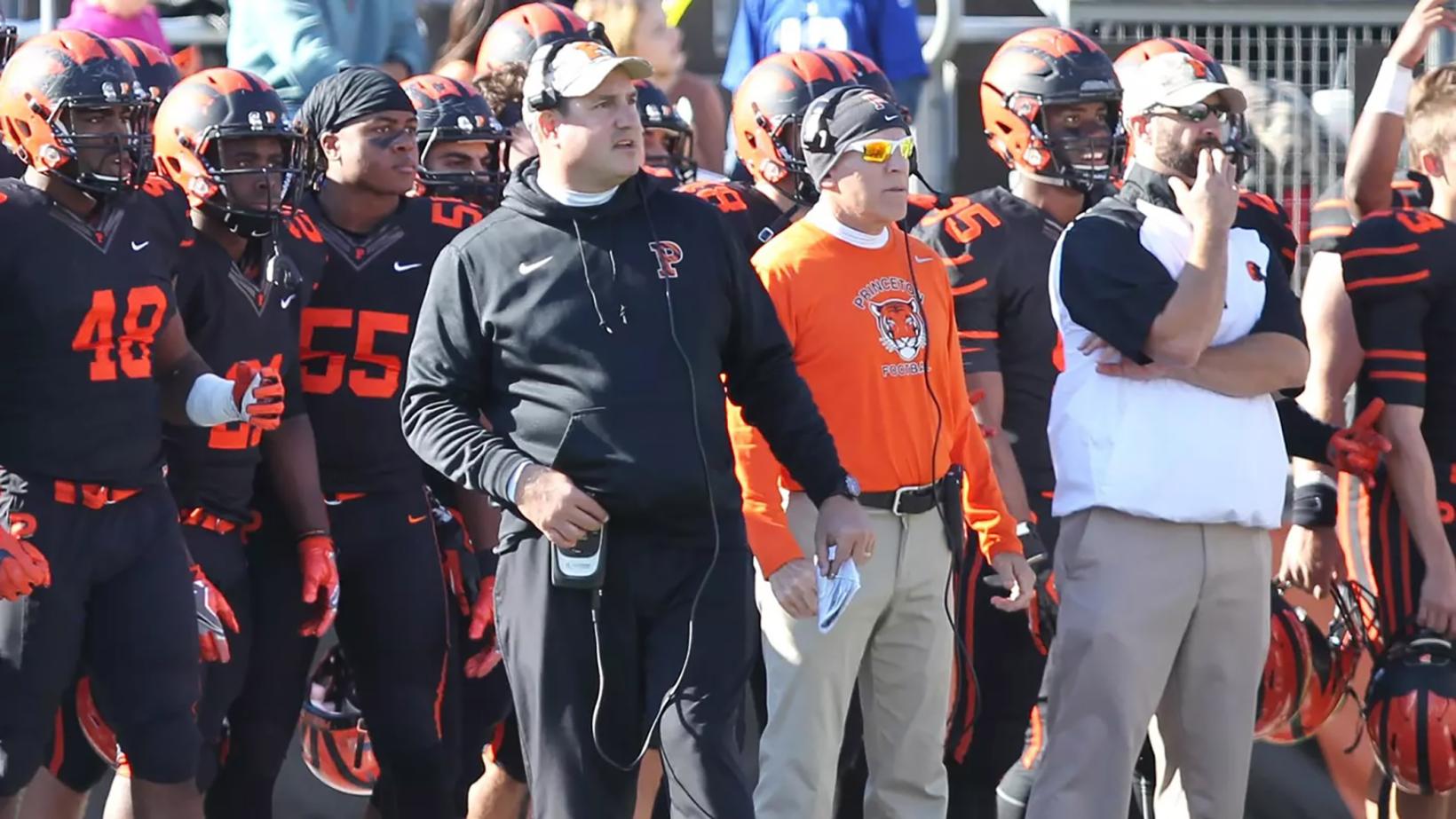 Head football coach Bob Surace and coaches and players on the Tigers sideline