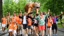 Group photo of alumni and children on P-rade route.