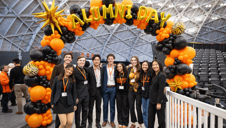 alums under balloons at Alumni Day 2025