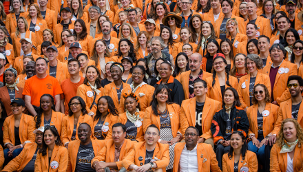 Class of 2000 members wearing orange jackets