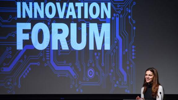 Innovation Forum with woman at lectern
