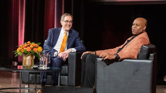 President Eisgruber smiling at Craig Robinson during a Venture Forward event in Chicago