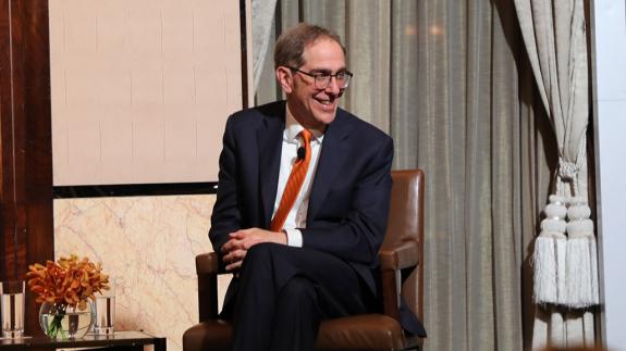President Eisgruber, smiling on stage of a Venture Forward event