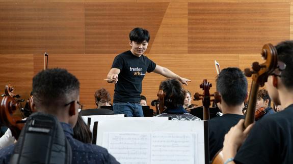 Lou Chen conducting the Trenton Student Orchestra