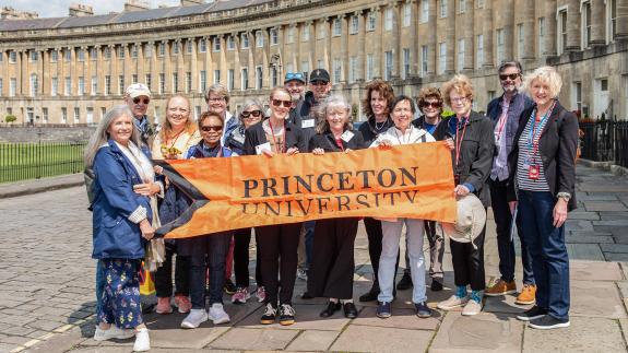 Princeton alumni and friends hold an orange Princeton banner in front of No. 1 Royal Crescent, part of the Jane Austen tour