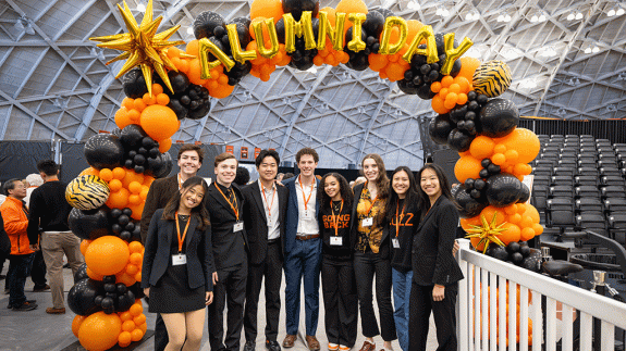 alums under balloons at Alumni Day 2025