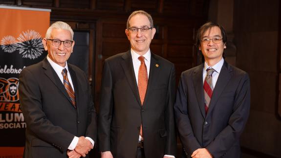 Kevin Gover, President Eisgruber and Terence Tao standing side by side on the stage of Richardson Auditorium.