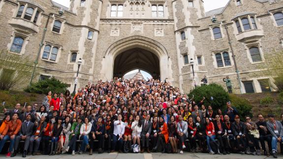 A group photo from the 2015 We Flourish conference with hundreds of Asian alumni on the steps of Blair Arch.