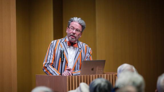 James Steward, winning and orange-striped Reunions jacket, speaks from the podium.
