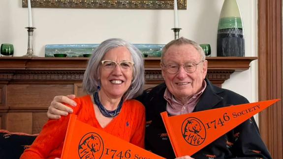 Ada and Tom Deuel hold 1746 Society pennants