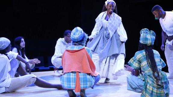 Students perform on stage with The Black Theater Initiative