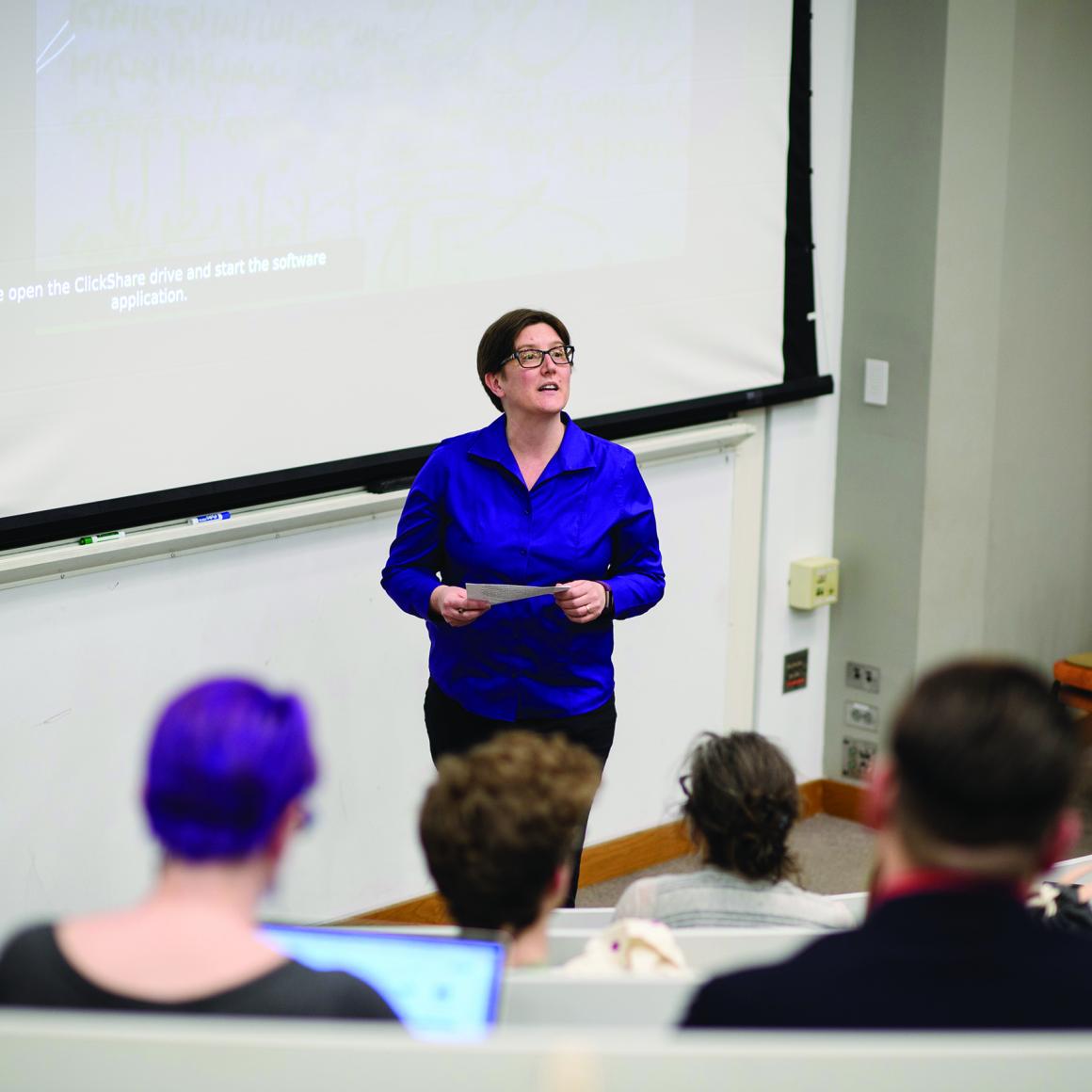 Professor Jennifer Rexford delivers lecture to students with projection screen behind her
