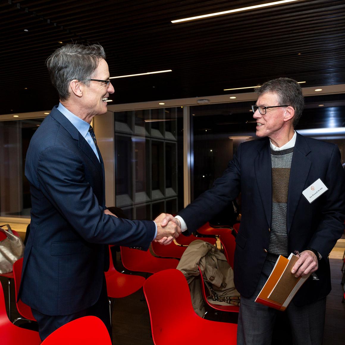 Audience members shaking hands