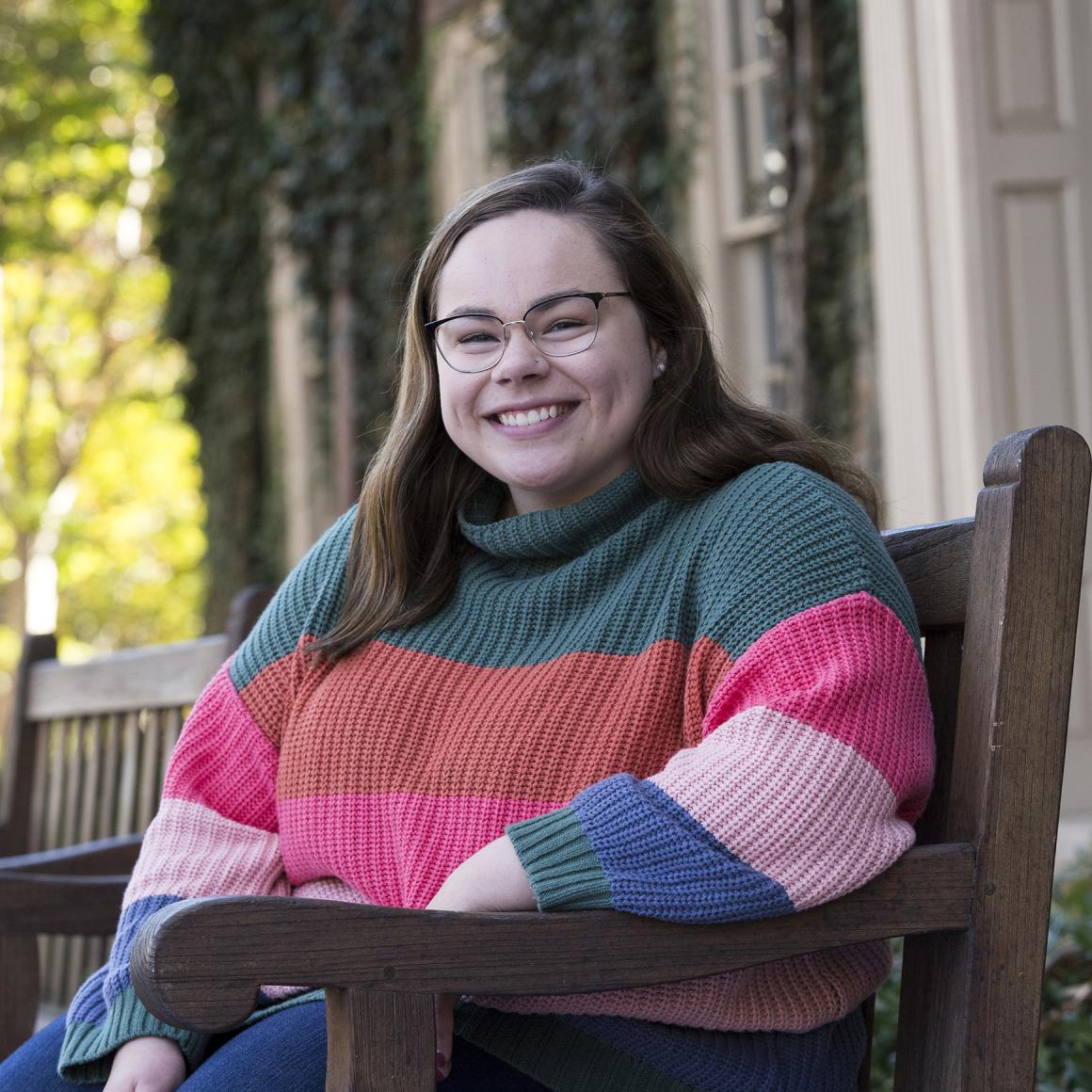 Danya Valek '20 seated in front of Princeton campus building