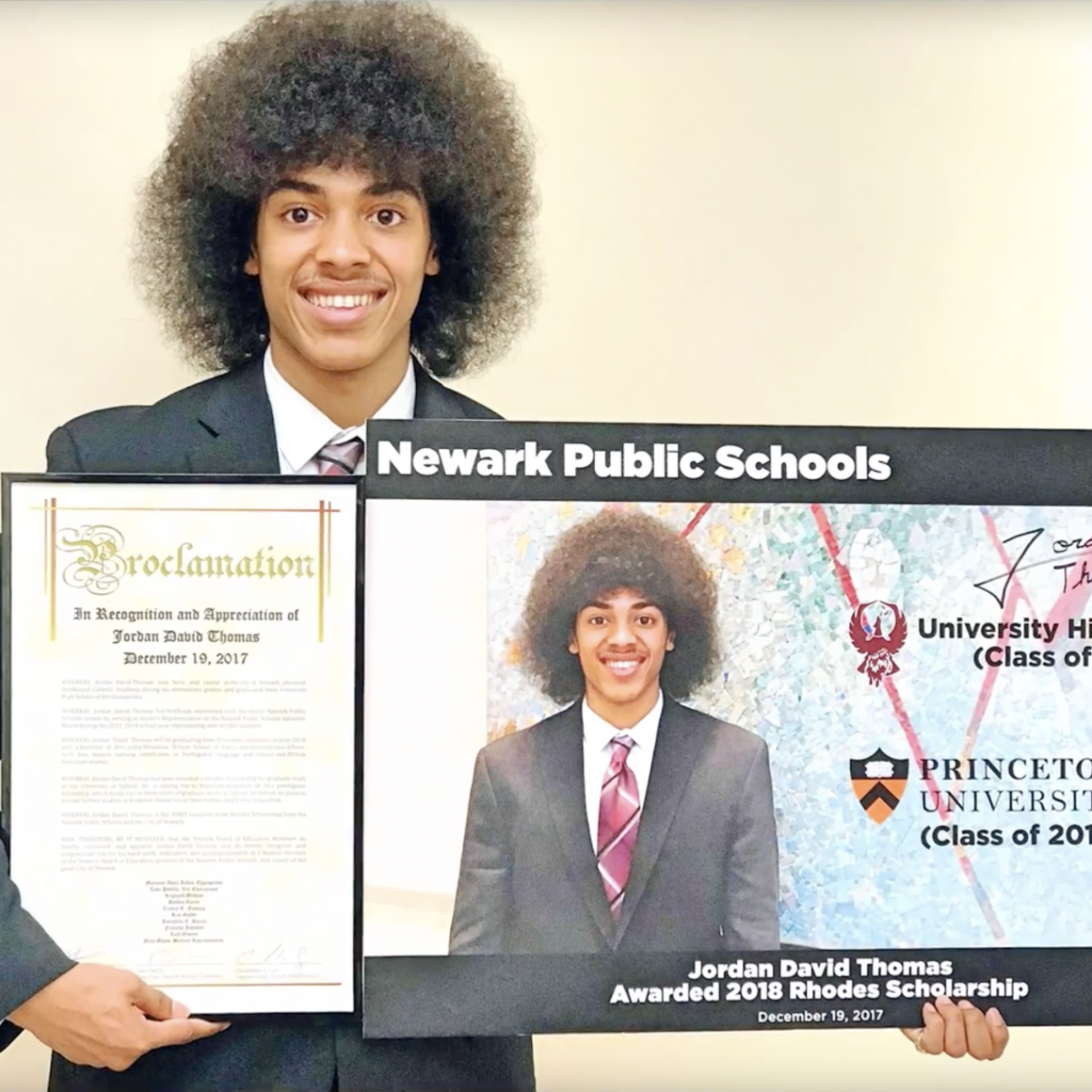 Jordan Thomas '18 Rhodes Scholar holding Newark Schools proclamation