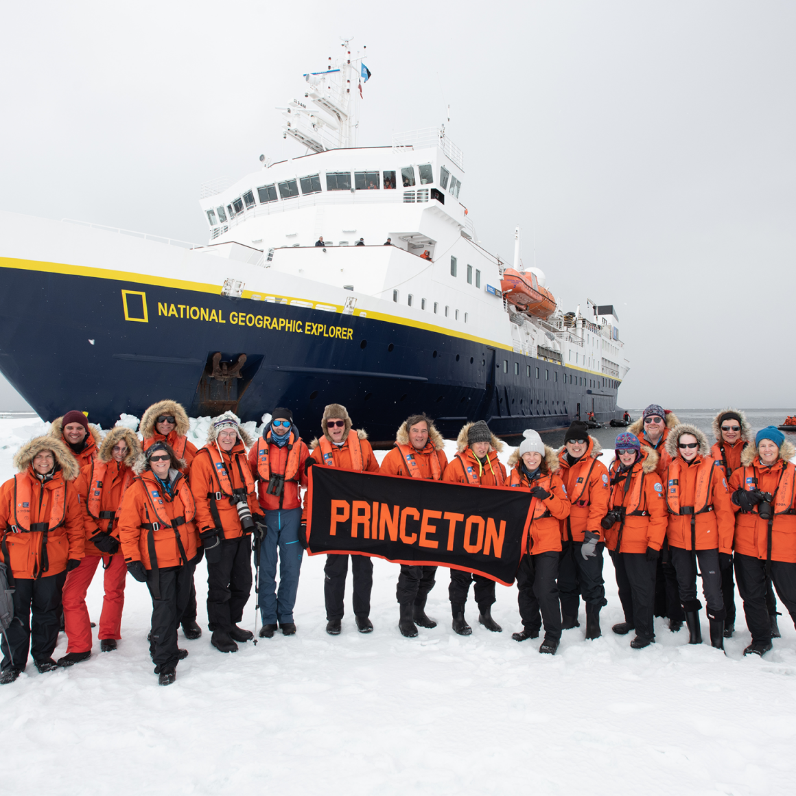 Group of travelers near cruise ship in Antarctica