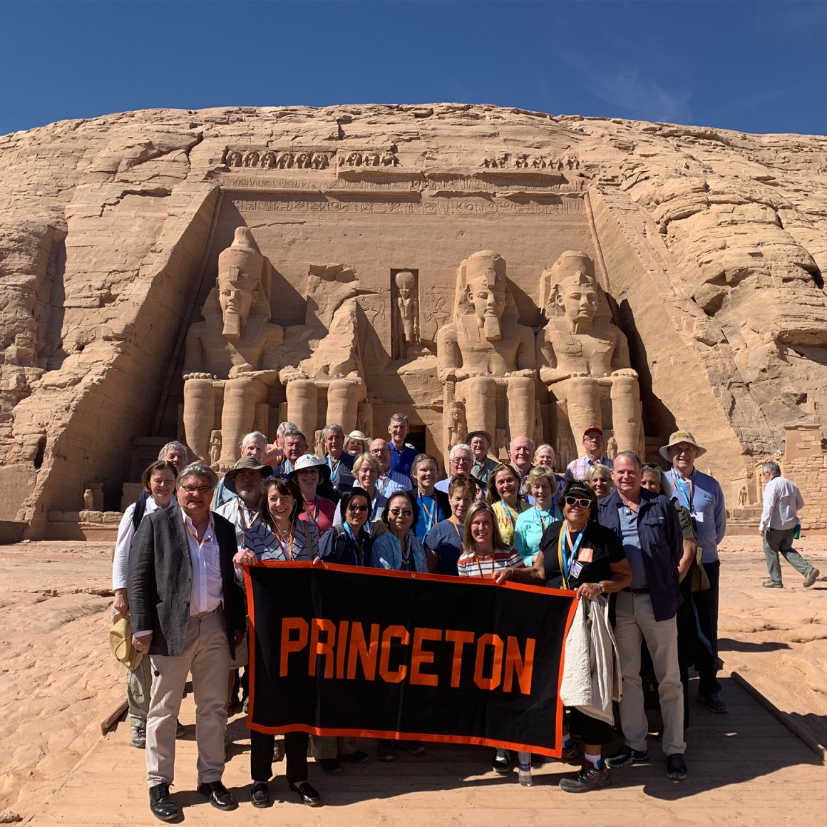 Travelers with Princeton banner in the Egyptian desert. 