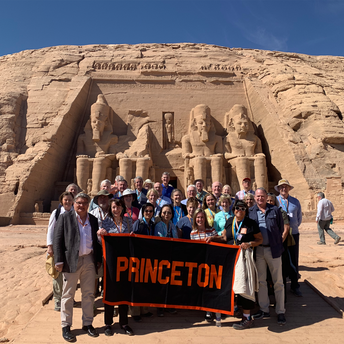 Travelers with Princeton banner in the Egyptian desert.