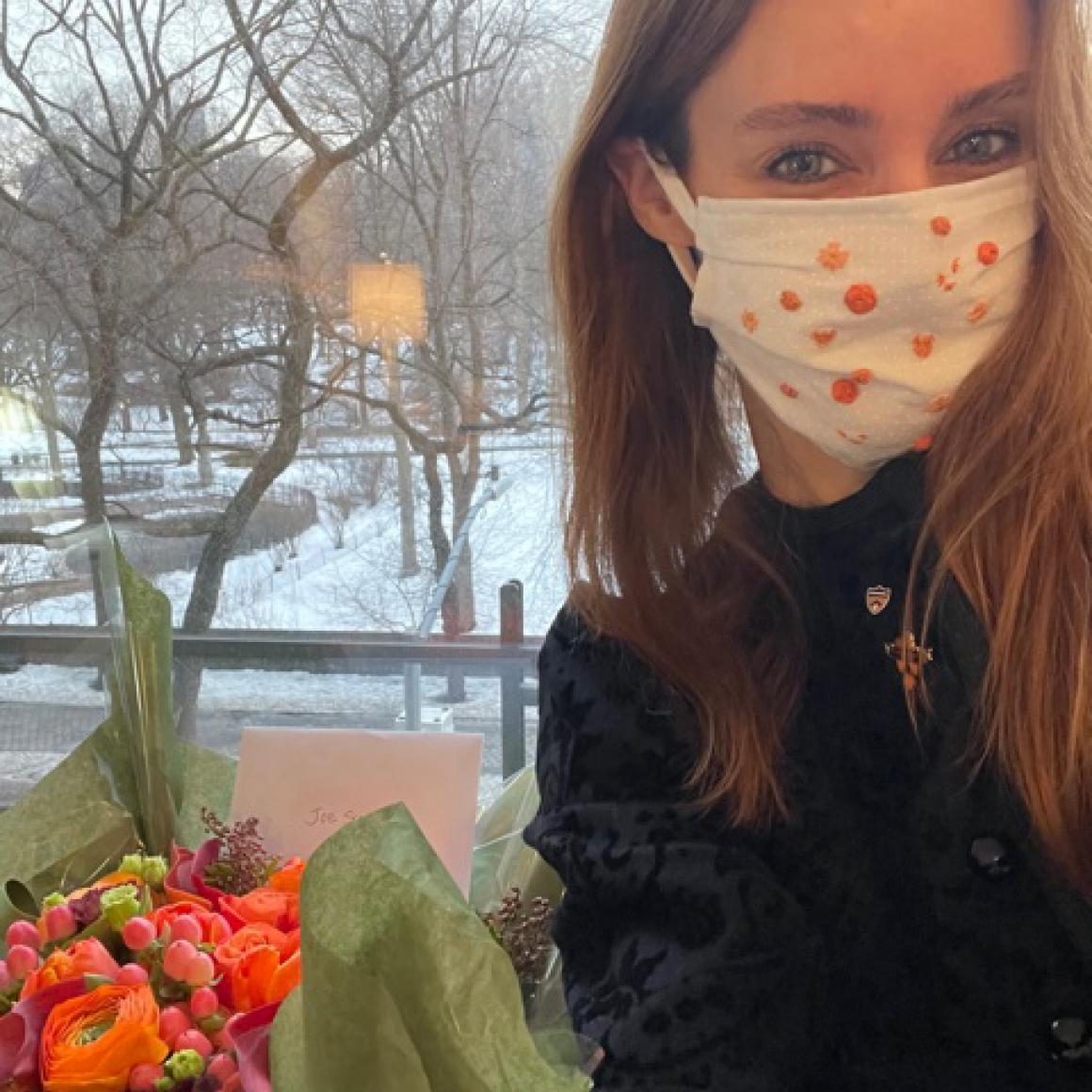 Kate Bellin '02 with birthday flowers for Joe Schein '37