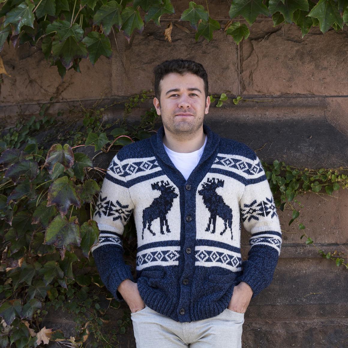 Vinny Wagner '21 standing in front of stone wall and ivy