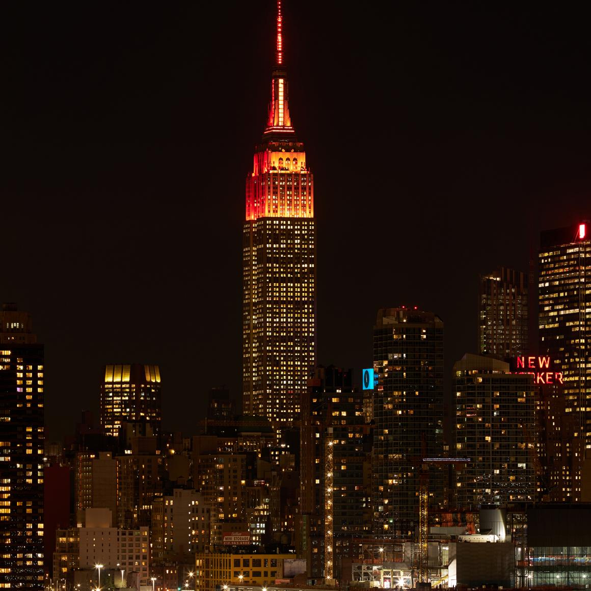 Empire State Building lighted orange at the top