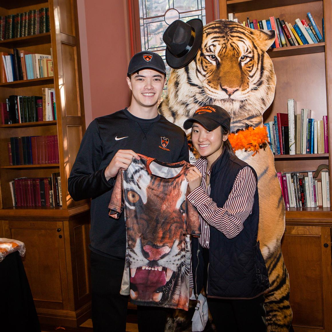Two alumni show their favorite Princeton gear at the 2022 ROAR event