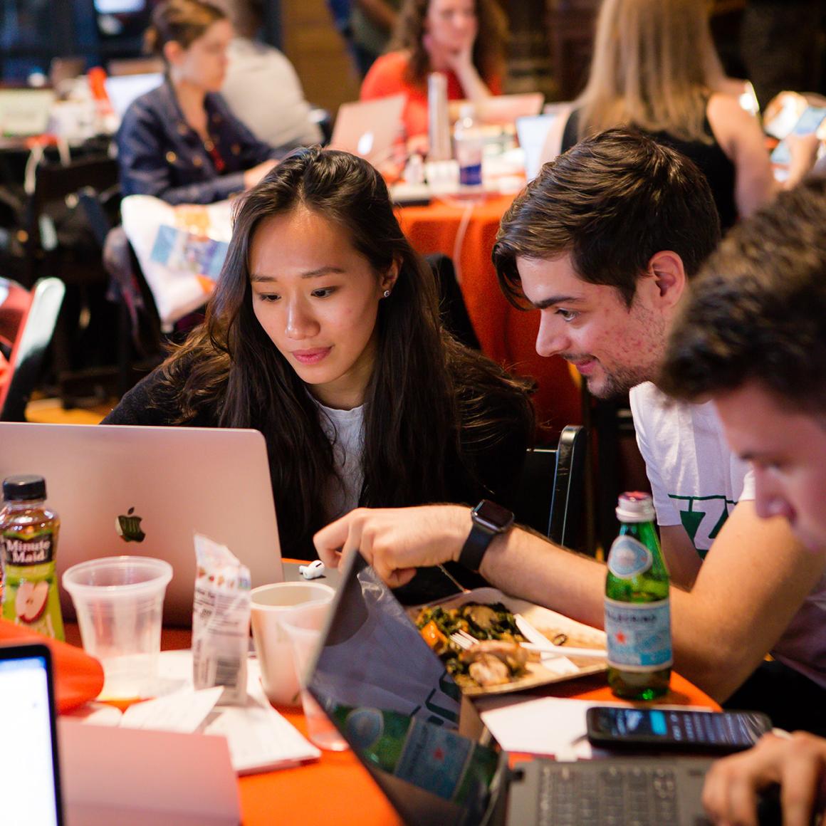 Princeton alumni studying their laptops