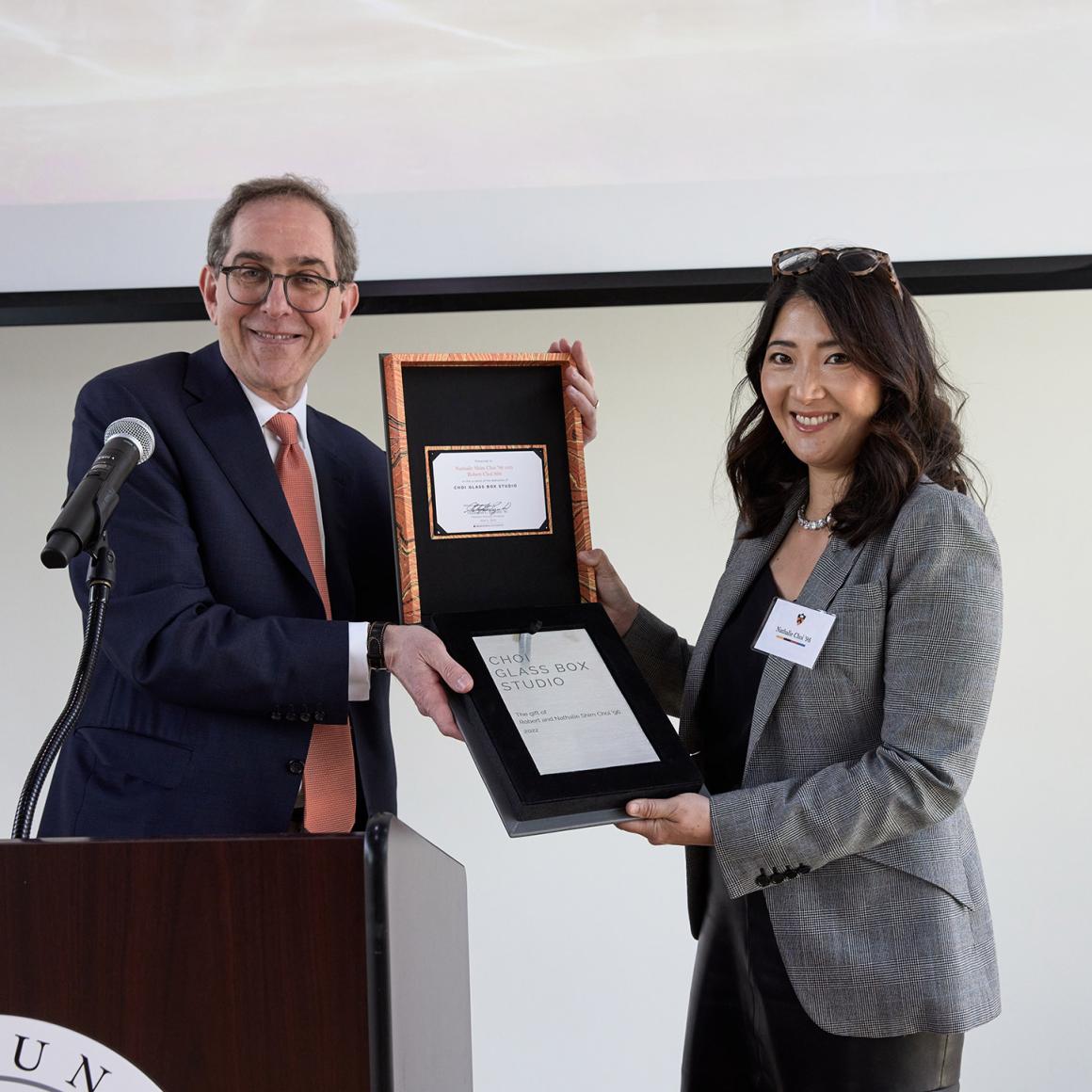Nathalie Choi holds her plaque with President Eisgruber